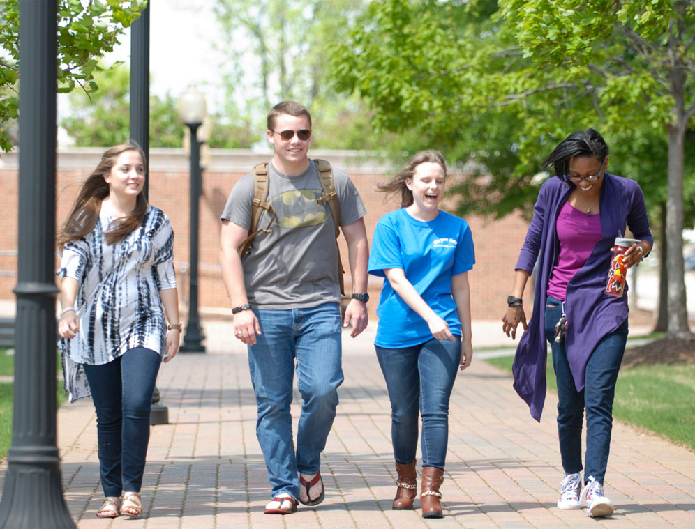 Group of Calhoun ambassadors walking on a sidewalk conversing