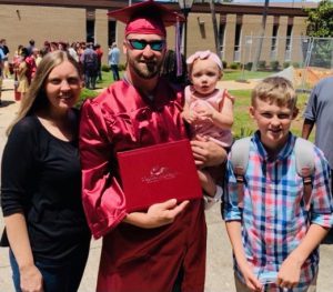 Coastal Alabama Community College Student Cody Burroughs poses with family and diploma.