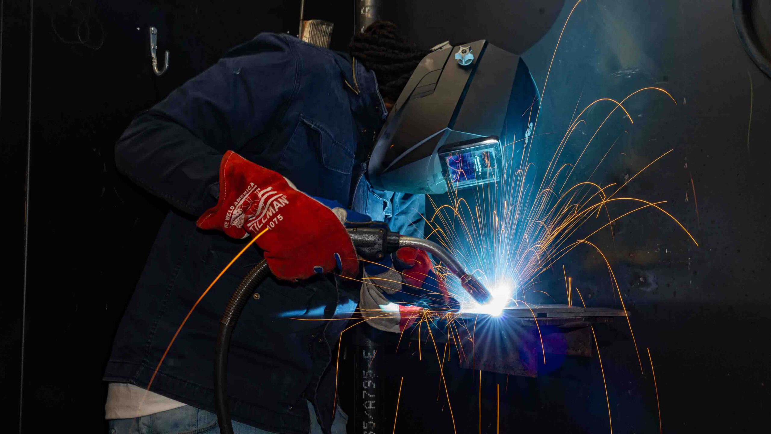 A student practicing welds.